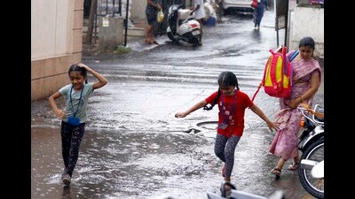 Girls play in puddles as rains lashed Sukhasagarnagar, Katraj, on Thursday. (Rahul Raut/HT PHOTO)