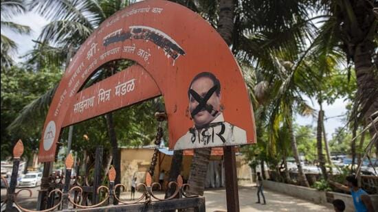 Shiv Sena workers paint black ink on the poster of MLA Sada Sarvankar who joined the rebel camp of Eknath Shinde in Guwahati, at Mahim, on Wednesday. (Satish Bate/HT PHOTO)