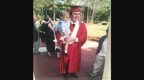 The image, taken from Reddit post, shows the dad with his son during his graduation ceremony.(Reddit/@bigK24)