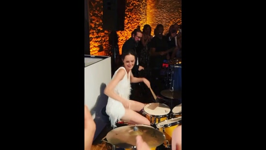 The image, taken from the Instagram video, shows the bride playing drums. (Instagram/@lainee_hunter)
