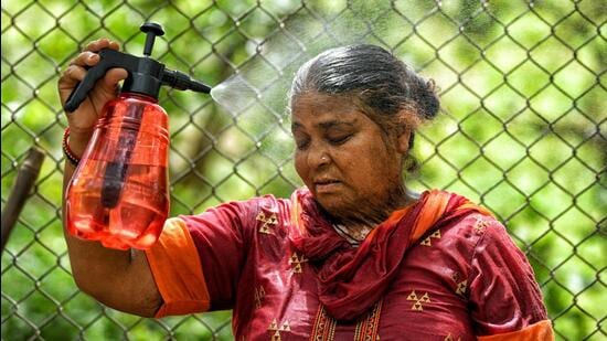 A woman tries to beat the heat on a hot summer day in New Delhi. (ANI Photo)