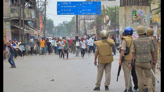 Protestors throw stones towards police during a protest against ‘Agnipath scheme’ for recruiting personnel for armed forces, in Varanasi, on June 17. (Reuters)