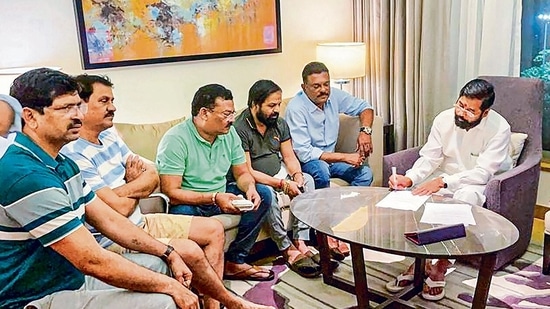 Rebel Shiv Sena leader Eknath Shinde with other MLAs during a meeting, in Guwahati on Wednesday. (PTI)(HT_PRINT)