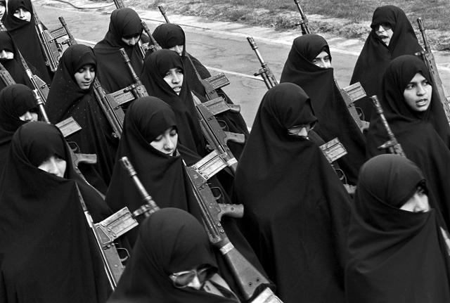 Basiji (mobilized volunteer force) women carrying G-3 automatic assault rifles march in a Tehran rally on 12 February 1987 towards the end of the eight year long Iran-Iraq war. (Kaveh Kazemi/Getty Images)