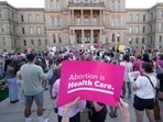 Abortion-rights protesters attend a rally following the United States Supreme Court's decision to overturn Roe v. Wade, federally protected right to abortion, outside the state capitol.