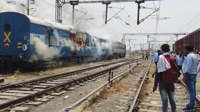 Chapra, India – June 16, 2022: Smoke billows from a train coach after it was set on fire by demonstrators during a protest against the 'Agnipath' army recruitment scheme at Chapra railway station, in Bihar, India, on Thursday, June 16, 2022. (Photo by Santosh Kumar /Hindustan Times) Chapra, India – June 16, 2022: Smoke billows from a train coach after it was set on fire by demonstrators during a protest against the 'Agnipath' army recruitment scheme at Chapra railway station, in Bihar, India, on Thursday, June 16, 2022. (Photo by Santosh Kumar /Hindustan Times)