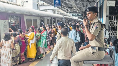 RPF officer seated on a watch tower keeps vigil on all the movements of commuters, at Dadar station. (Pratik Chorge/HT PHOTO)