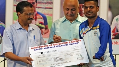 Delhi Chief Minister Arvind Kejriwal hands over a cheque of Rs. 8 Lacs to para-athlete Vijay Kumar under the Delhi Government's Mission Excellence Scheme during a ceremony. (ANI) Delhi Chief Minister Arvind Kejriwal hands over a cheque of Rs. 8 Lacs to para-athlete Vijay Kumar under the Delhi Government's Mission Excellence Scheme during a ceremony. (ANI)