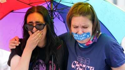 Abortion-rights activists react after hearing the Supreme Court decision on abortion outside the Supreme Court in Washington. (AP)