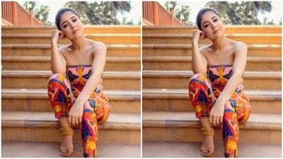 Shweta decked up in an off-shoulder cropped top featuring quirky patterns in shades of pink, yellow, blue and orange. She paired it with a pair of trousers of the same print. (Instagram/@battatawada)