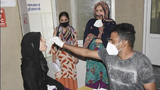 A health worker collects a nasal sample for Covid-19 test at MMG Hospital in Ghaziabad. (Sakib Ali)