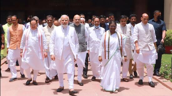 NDA's candidate Droupadi Murmu, accompanied by Prime Minister Narendra Modi, Union Ministers Rajnath Singh, Amit Shah, BJP president JP Nadda and others walk towards Parliament House to file her nomination papers for the Presidential polls in New Delhi on Friday. (TWITTER.) NDA's candidate Droupadi Murmu, accompanied by Prime Minister Narendra Modi, Union Ministers Rajnath Singh, Amit Shah, BJP president JP Nadda and others walk towards Parliament House to file her nomination papers for the Presidential polls in New Delhi on Friday. (TWITTER.)