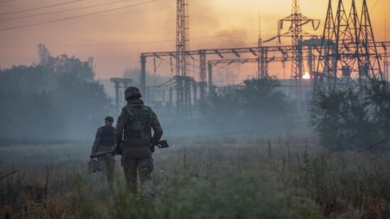Ukrainian service members patrol an area in the city of Sievierodonetsk.(REUTERS)