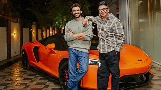 Kartik Aaryan and Bhushan Kumar posing with his new McLaren GT.