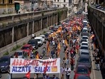 Demonstrators hold a banner reading put down the weapons raise up the salaries, during a transportation strike called by the COBAS union, in downtown Rome.(AP) Demonstrators hold a banner reading put down the weapons raise up the salaries, during a transportation strike called by the COBAS union, in downtown Rome.(AP)
