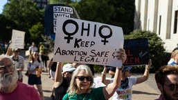 An abortion rights protester holds a sign to keep abortion safe in Ohio at a rally in Columbus, on June 24, 2022.&nbsp;