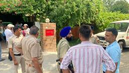 Police personnel outside the house of Punjab IAS officer Sanjay Popli in Chandigarh on Saturday after his son, Kartik, died of a gunshot wound in the head. (HT Photo)