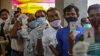 People in queue to cast their votes for the Rajinder Nagar bypoll election, show their identity cards inside a polling station at Dasghara in New Delhi. (HT Photo) People in queue to cast their votes for the Rajinder Nagar bypoll election, show their identity cards inside a polling station at Dasghara in New Delhi. (HT Photo)