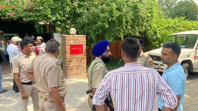 Police personnel outside the house of Punjab IAS officer Sanjay Popli in Chandigarh on Saturday after his son, Kartik, died of a gunshot wound in the head. (HT Photo)