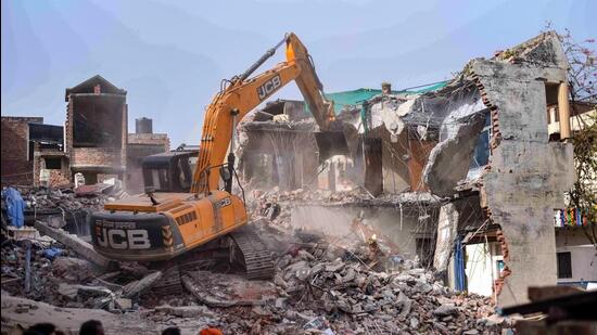 Bulldozer being used to demolish the 'illegally constructed' residence of Javed Ahmed, a local businessman who was allegedly the key conspirator of violent protests against remarks on Prophet Mohammed, in Prayagraj on June 12. (PTI) Bulldozer being used to demolish the 'illegally constructed' residence of Javed Ahmed, a local businessman who was allegedly the key conspirator of violent protests against remarks on Prophet Mohammed, in Prayagraj on June 12. (PTI)