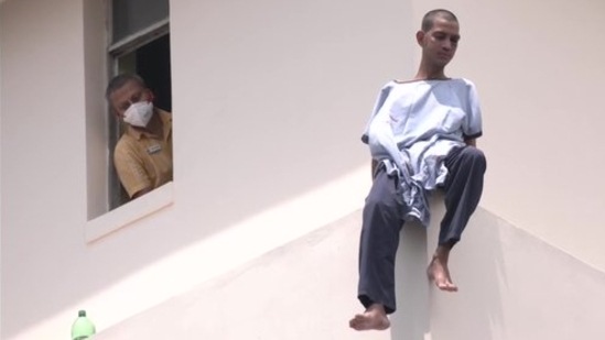 A patient climbed and sat on the window pane of a high rise hospital building in Kolkata.