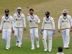 Virat Kohli walks out on the field with with teammates
