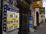Foreign currency exchange rates for US dollars, Russian rubles and British pounds displayed outside an exchange bureau in Riga, Latvia.(Bloomberg) Foreign currency exchange rates for US dollars, Russian rubles and British pounds displayed outside an exchange bureau in Riga, Latvia.(Bloomberg)