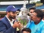 Madhya Pradesh's captain Aditya Shrivastava and head coach Chandrakant Pandit kiss the trophy after winning their final Ranji Trophy cricket match against Mumbai, at M Chinnaswamy Stadium in Bengaluru.(PTI)