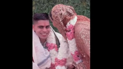 The bride and groom share a light moment after he touches her feet at their wedding.&nbsp; (Instagram/@ditigoradia)