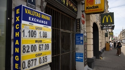 Foreign currency exchange rates for US dollars, Russian rubles and British pounds displayed outside an exchange bureau in Riga, Latvia. (Bloomberg)