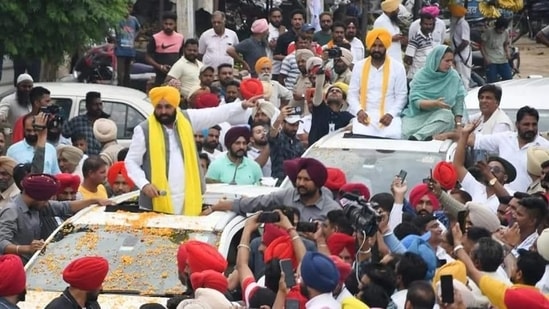 Punjab CM Bhagwant Mann taking out a road show along with AAP candidate Gurmail Singh in Sangrur on Tuesday. (HT Photo)