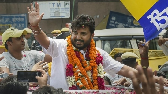 AAP candidate Durgesh Pathak waves at his supporters during celebrations after winning the Rajinder Nagar by-election in New Delhi.(PTI)