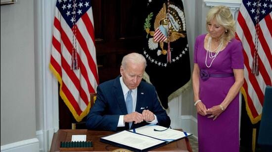 US First Lady Jill Biden looks on as US President Joe Biden signs the Bipartisan Safer Communities Act into law, in the Roosevelt Room of the White House in Washington, DC, on Saturday. (AFP)