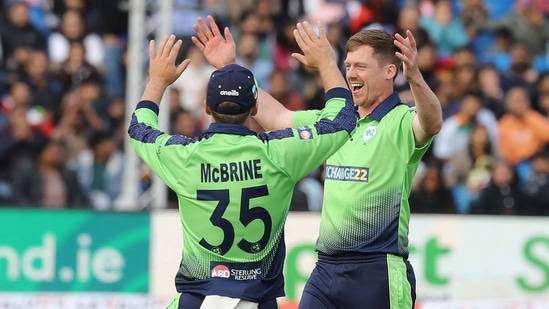 Craig Young (R) celebrates after taking the wicket of Suryakumar Yadav(AFP)