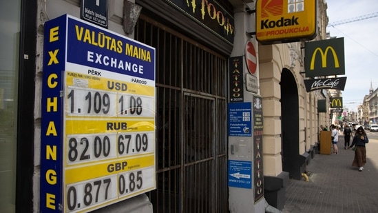 Foreign currency exchange rates for US dollars, Russian rubles and British pounds displayed outside an exchange bureau in Riga, Latvia.(Bloomberg) Foreign currency exchange rates for US dollars, Russian rubles and British pounds displayed outside an exchange bureau in Riga, Latvia.(Bloomberg)