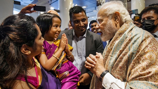 PM Modi interacts with a child who came to the hotel in Munich to welcome him.(PTI)
