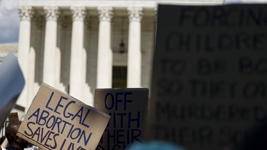 bortion rights activists hold signs during a protest in front of the Supreme Court building following the announcement to the Dobbs v Jackson Women's Health Organization ruling on June 25, 2022 in Washington, DC.&nbsp;(AFP)