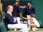 Jodie Burrage gives a ballboy some refreshments after he fainted during her women's singles first round match at Wimbledon Jodie Burrage gives a ballboy some refreshments after he fainted during her women's singles first round match at Wimbledon