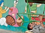 This hot afternoon he has escaped into a brief nap on his rickshaw, which is parked beside the painted wall. This hot afternoon he has escaped into a brief nap on his rickshaw, which is parked beside the painted wall.