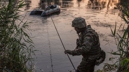 FILE PHOTO: Ukrainian service members cross a river outside the city of Sievierodonetsk, as Russia's attack on Ukraine continues, Ukraine June 19, 2022. REUTERS/Oleksandr Ratushniak