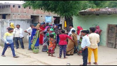 A crowd at the site where the incident took place in Dhari village of Prayagraj. (HT photo)