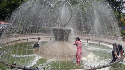 People cool off under a fountain on a hot summer day in New Delhi. (ANI Photo) People cool off under a fountain on a hot summer day in New Delhi. (ANI Photo)