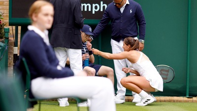 Jodie Burrage gives a ballboy some refreshments after he fainted during her women's singles first round match at Wimbledon (AP) Jodie Burrage gives a ballboy some refreshments after he fainted during her women's singles first round match at Wimbledon (AP)
