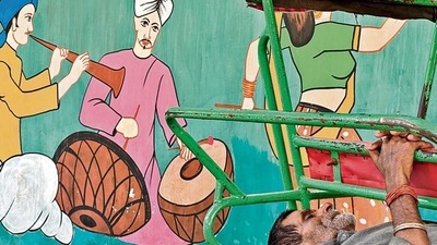 This hot afternoon he has escaped into a brief nap on his rickshaw, which is parked beside the painted wall. This hot afternoon he has escaped into a brief nap on his rickshaw, which is parked beside the painted wall.