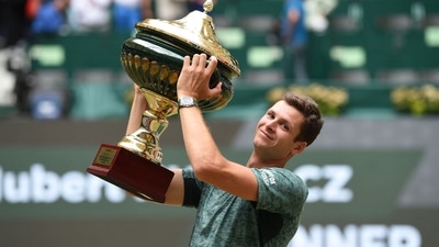 Poland's Hubert Hurkacz celebrates with the trophy after winning his singles final match against Russia's Daniil Medvedev at the ATP 500 Halle Open (AFP)