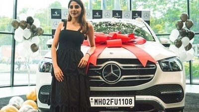 Nikki Tamboli poses with her new car.