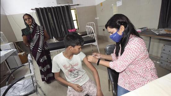 A health worker administers a dose of Covid-19 vaccine to a boy at a community health centre in Dasna, Ghaziabad. (Sakib Ali/ HT)