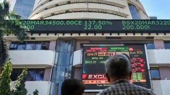 People watch the Sensex on a screen outside Bombay Stock Exchange (BSE) in Mumbai.&nbsp;