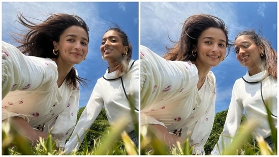 Alia enjoyed a picnic date with her friend in London, dressed in a white summer dress adorned with lilac-coloured patterns. She accessorised the look with gold hoop earrings, an open hairdo and soft glam.(Instagram)