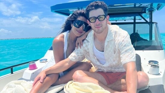 For chilling on the yacht, Priyanka donned a metallic-toned bikini set layered with a white sleeveless wrap jacket. She styled the look with black-tinted OTT sunglasses, mauve lip shade and sunkissed skin. Meanwhile, Nick complemented her in a sheer embroidered shirt, tank top, orange coloured shorts, quirky glasses and a digital watch.(Instagram)